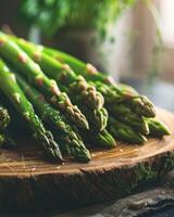 Bunch of green asparagus on wooden board photo