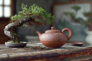 Traditional teapot made from red clay placed on an old wooden table. photo