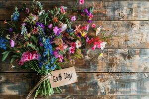 Beautiful colorful flowers bouquet over rustic wood background. photo