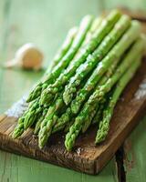Bunch of green asparagus on wooden board photo