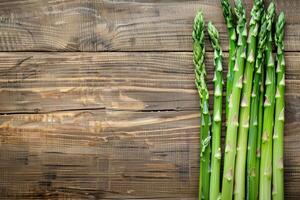 Fresh asparagus on wooden background photo
