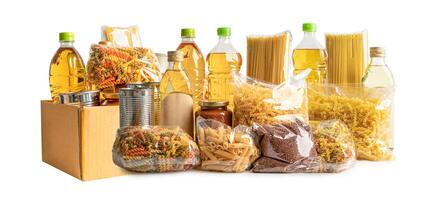 Foodstuff for donation, storage and delivery. Various food, pasta, cooking oil and canned food in cardboard box. photo