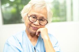 Asian senior woman wearing eyeglasses or vision glasses at home care service. photo