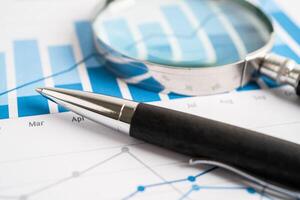 Pen on chart or graph paper. Financial, account, statistics and business data concept. photo