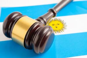 Judge lawyer and US dollar banknotes on Argentina flag, law finance concept. photo