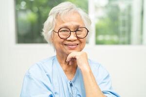 Asian senior woman wearing eyeglasses or vision glasses at home care service. photo