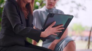 Close-up of confident Asian female financial advisor explaining the advantages of the deal. Display presentations on the computer to focus on the customer. video