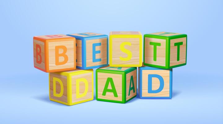 3d wooden alphabet toy blocks spelling the word best dad. Father's Day elements isolated on light blue background.