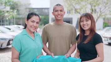 Close-up of two women and a man holding plastic bags to put in trash cans. slow movement Separate waste that cannot be biodegraded. video