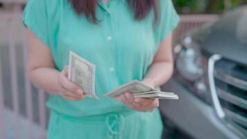 Close-up of happy woman counting money radiates confidence and success in investing. video