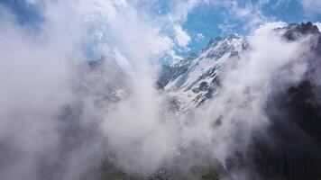 Fantastic mountain scenery of snow-covered alpine peaks Aerial view video