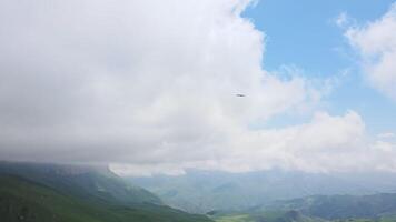 Aerial view of a bird of prey descending from the sky on a drone shooting it video