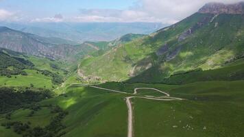 Aerial view of a beautiful green valley and road in the mountains video