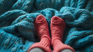 feet in warm red socks on a birch blanket photo