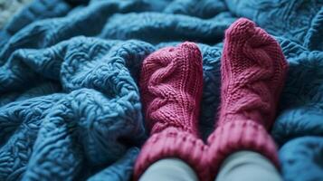 feet in warm red socks on a birch blanket photo