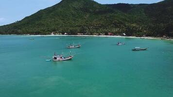 Flying over the water of a beach with many boats nature 4k Background video