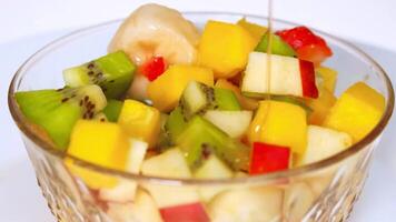 Rotating bowl with fruit on a white background 4K background video