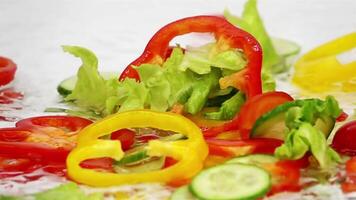 Slices of vegetables falling into the water 4k background video