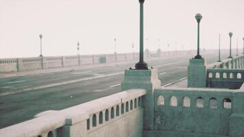 An empty illuminated asphalt road in a thick fog video