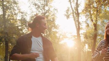 Young asian male performer holding the hands of his female partner and dancing cheerfully close up in a city park on a sunny day. Concept of outdoor active summer leisure video