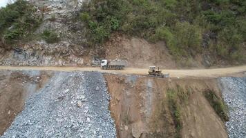 Aerial view of an active quarry with heavy machinery at work, emphasizing environmental impact related to Earth Day concerns video