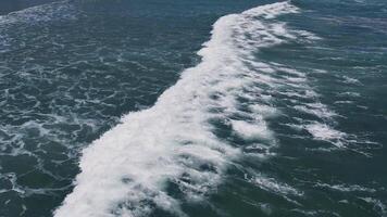 Aerial view of ocean waves creating white foam, suitable for environmental concepts and Earth Day promotional materials video