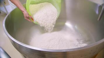 Pouring flour into an industrial mixer video