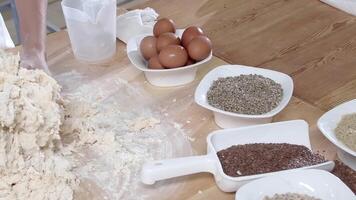 Stirring eggs into a pile of flour on the table video