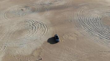 Car is driving in the desert. Dubai, drone camera video