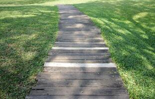 A row of wooden walkways in the garden with natural background photo