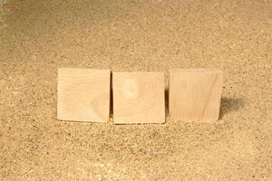 wooden cube on on the sand photo