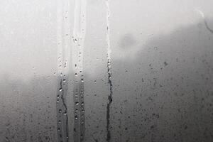Water droplets from steam on the glass surface photo