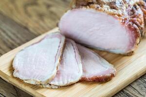 Baked meat on the wooden board photo