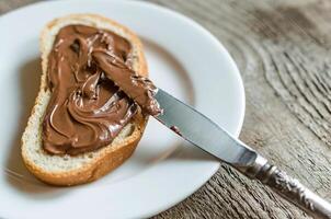 Slice of bread with chocolate cream photo