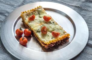 Lasagna on the metal plate photo