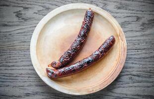 Grilled sausages on the plate photo