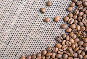 Coffee beans with bamboo background photo