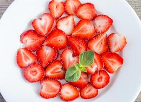 Mint leaves and sliced Strawberries at background photo