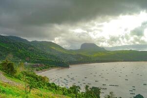 natural scenery of gemah beach and popoh bay facing the south sea of java island or indian ocean decorated with some mountains photo