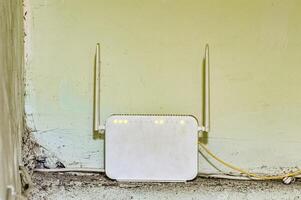 a white wifi router with two antennas photo