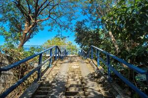 a concrete staircase part of a pedestrian bridge that crosses the Surabaya-Gresik toll road photo