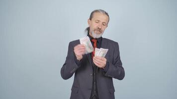 Rich businessman counting money. video