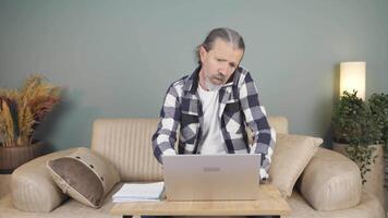 Man using laptop nervously talking on the phone. video