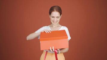 Happy and joyful woman opening gift package. video