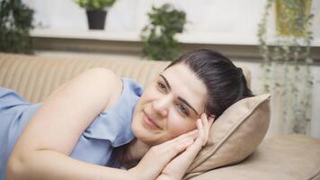 Woman lying on the sofa is resting. video