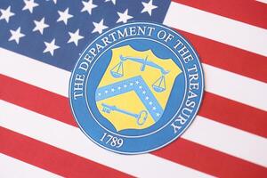 KYIV, UKRAINE - MARCH 9, 2024 US The Department of the Treasury seal on United States of America flag photo