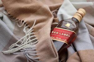 KYIV, UKRAINE - NOVEMBER 27, 2023 Johnnie Walker red label scotch whisky bottle photo