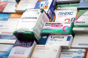 KYIV, UKRAINE - NOVEMBER 27, 2023 Many boxes of pills and capsules stacked in pharmacy drug store photo