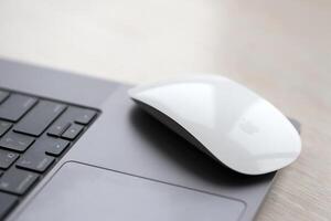 KYIV, UKRAINE - NOVEMBER 27, 2023 Apple Magic Mouse 3rd generation lies with grey MacBook 2021 photo