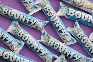 KYIV, UKRAINE - OCTOBER 31, 2023 Bounty chocolate bars with cocoa flavor filling. Bounty chocolate bar is a brand of American Mars Inc photo